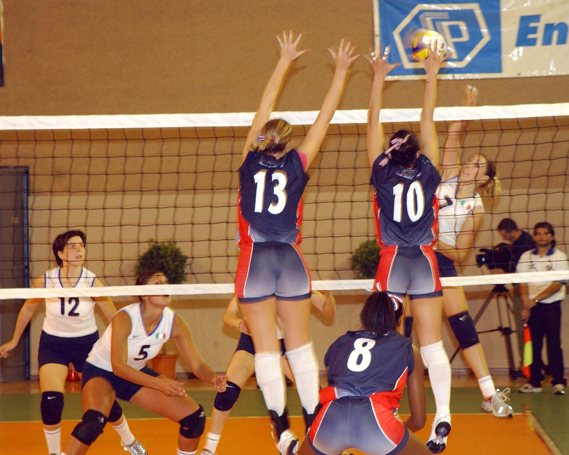 Volleyball player at the net mid-play